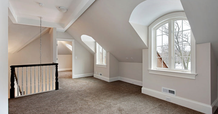 An upstairs loft features new wall-to-wall carpeting. Natural light pours in from two large dormer windows.